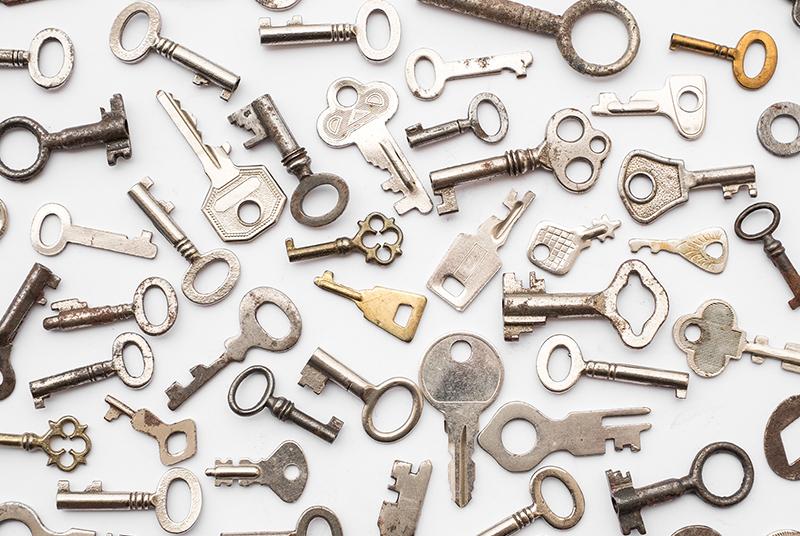 Assorted metal keys on a white background