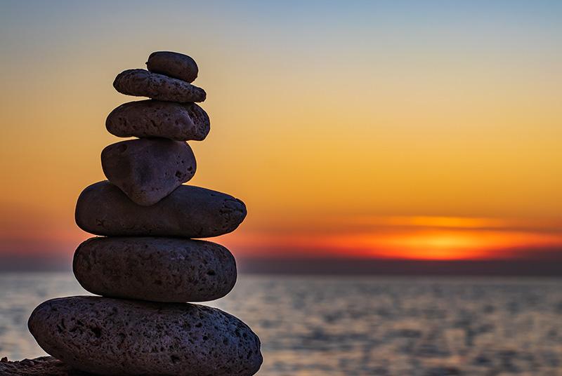 A cairn with sunset in the background