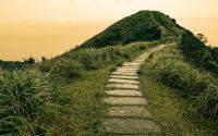 Fairy tale landscape and stepping stone path over a hill on the horizon at the Caoling Historic Trail in Taiwan