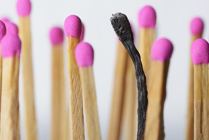 Pink topped wooded matches with one match burned out