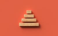 A stack of wood blocks forming a pyramid on an orange background