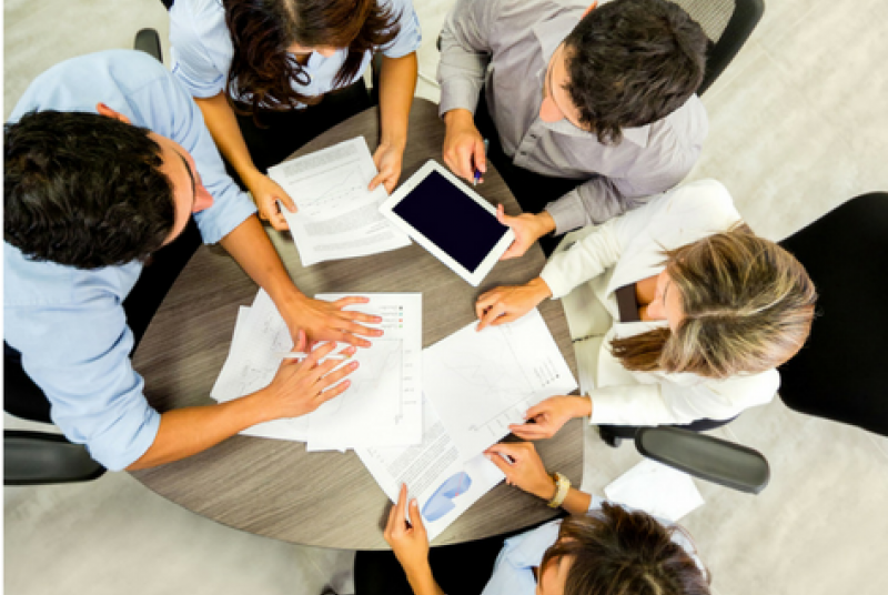 Teammates around conference table